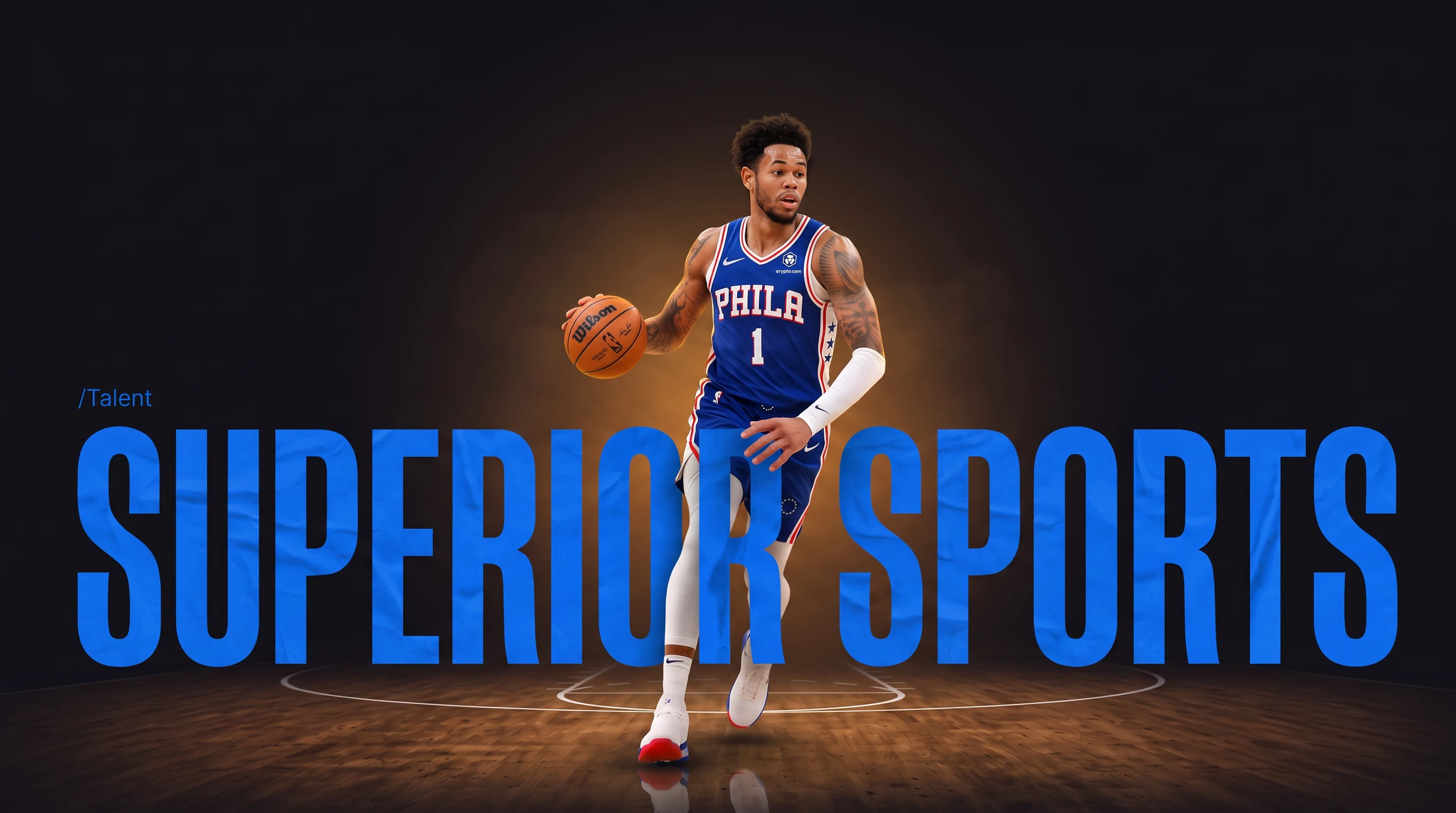 A basketball player driving with the ball across a warmly lit hardwood court, the words SUPERIOR SPORTS set large in blue behind and around him. The player is desaturated until a cursor passes over him.
